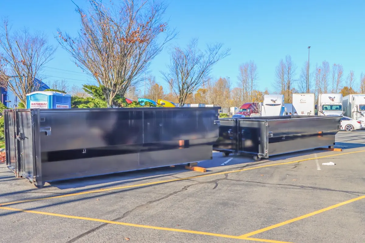 Professional dumpster rental service with roll-off container on residential driveway in South El Monte